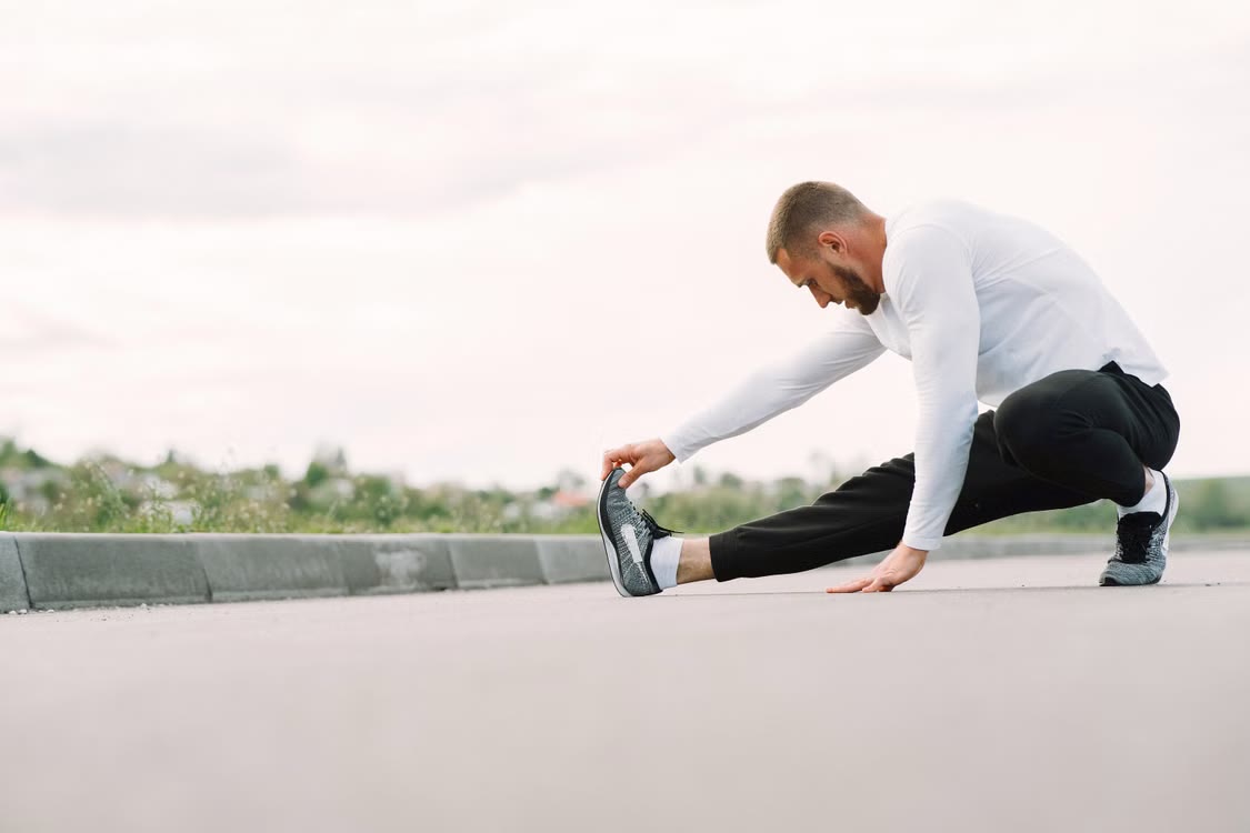 Man stretching outdoors before physical activity.